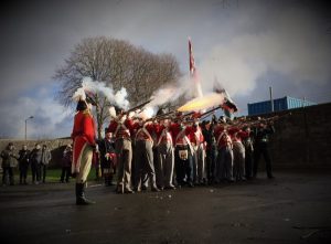 32nd of Foot reenactment group fire their muskets