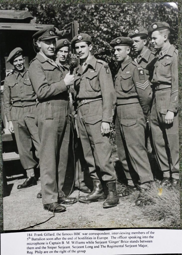 Frank Gillard, BBC, interviewing members of 5/DCLI. The Wessex Wyvern insignia is visible on their uniforms. 